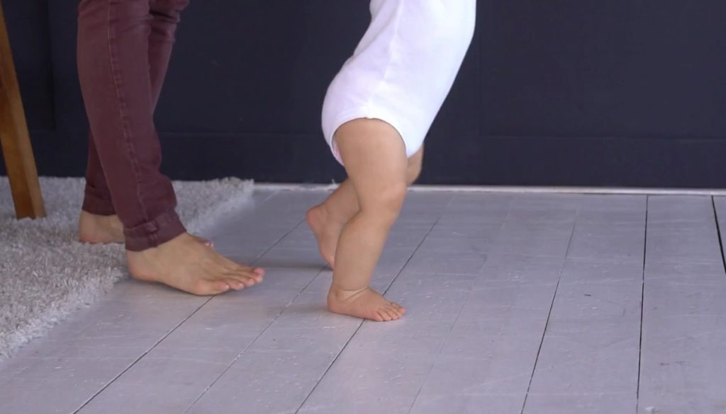 mother-with-baby-girl-learning-to-walk